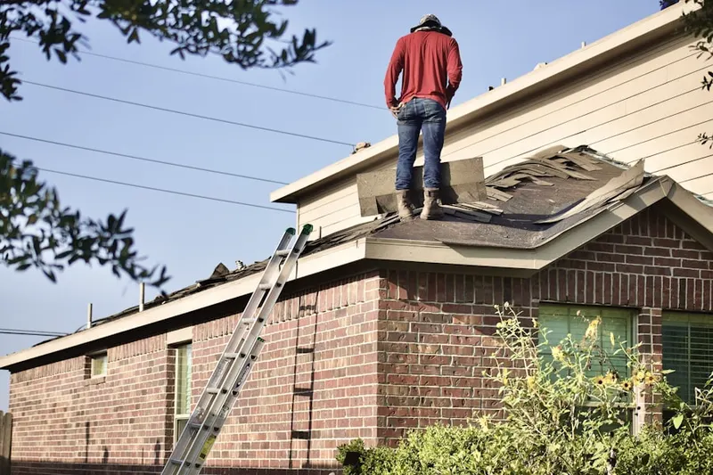 Professional roofer working on a residential roof in Broadway Estates